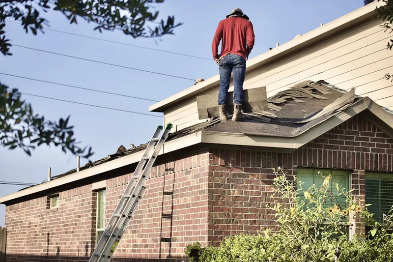 Professional roofer working on a residential roof in St. Martin